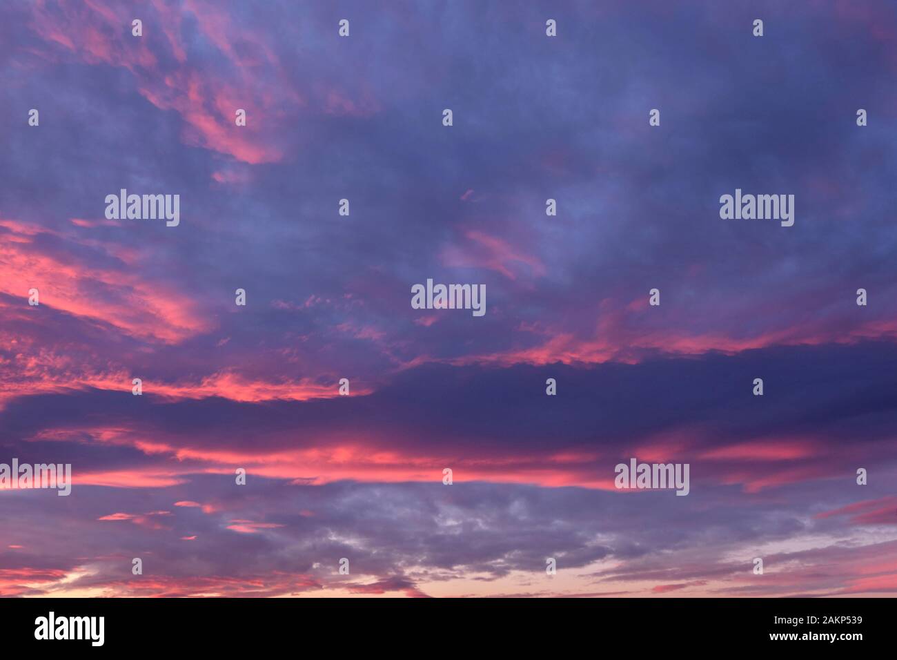 dramatic cloudy sky in the rays of setting sun. Stock Photo