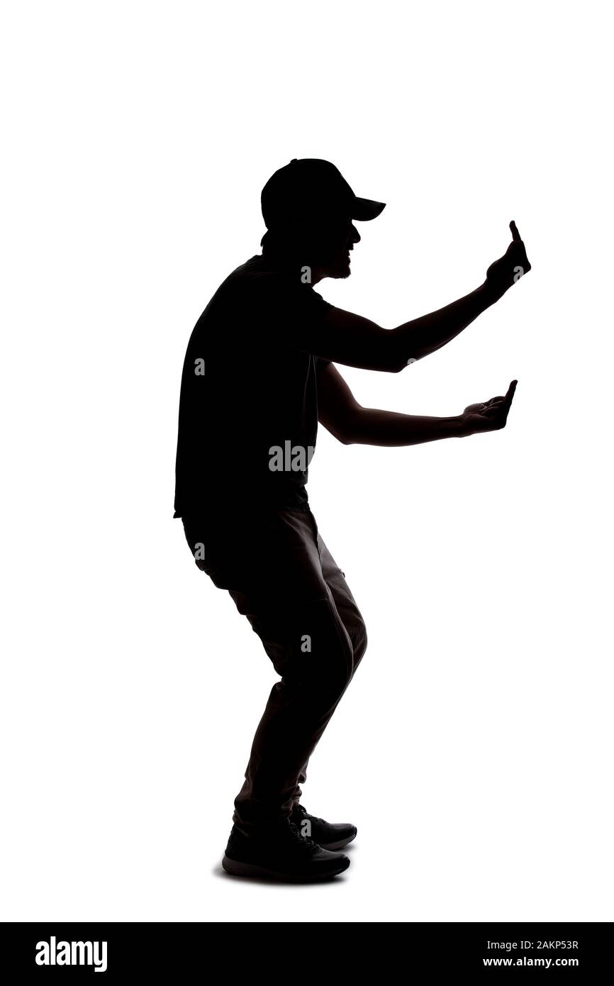 Silhouette of a man wearing casual clothes isolated on a white background. He is being rude and angry Stock Photo