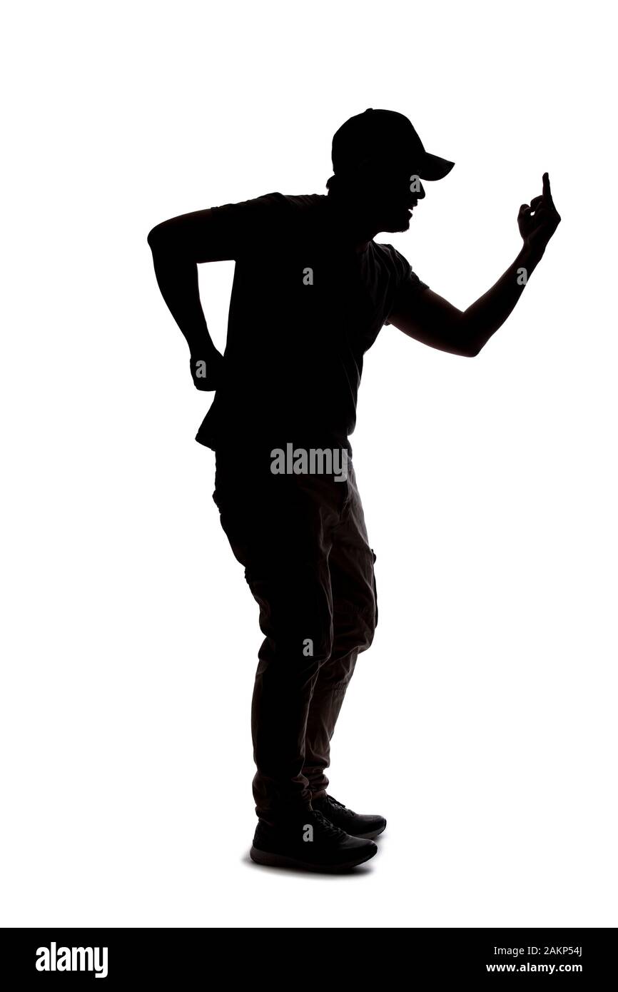 Silhouette of a man wearing casual clothes isolated on a white background. He is being rude and angry Stock Photo