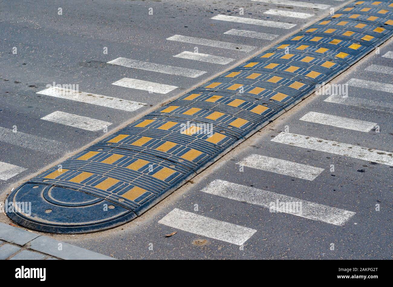 Speed bump on a city street. Speed bump and road markings on the