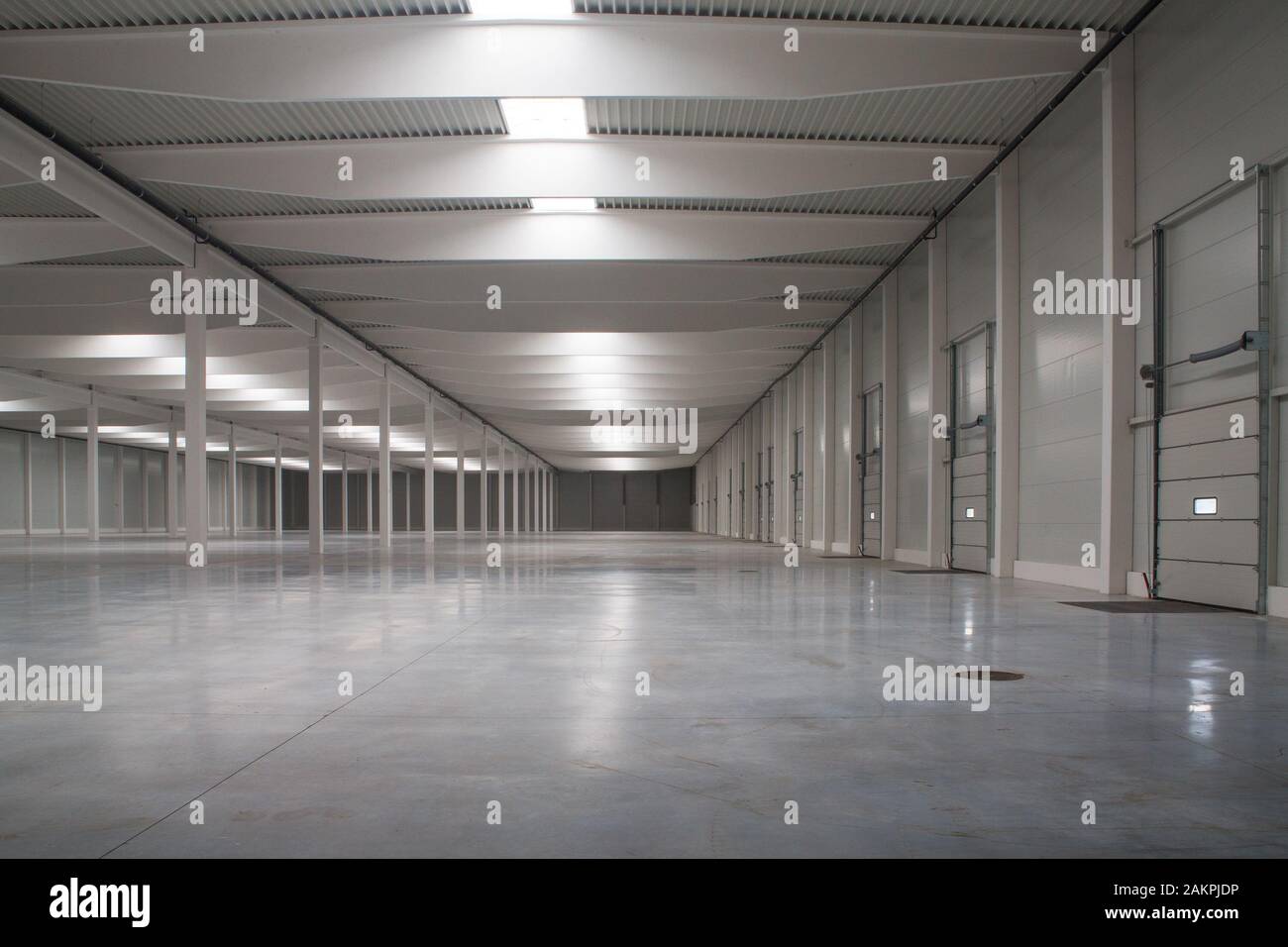 empty warehouse with white floor and high ceiling Stock Photo