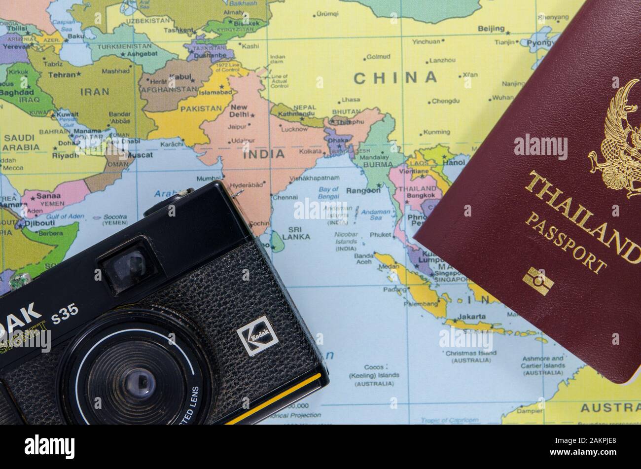 thai passport with black camera lay on asia map Stock Photo