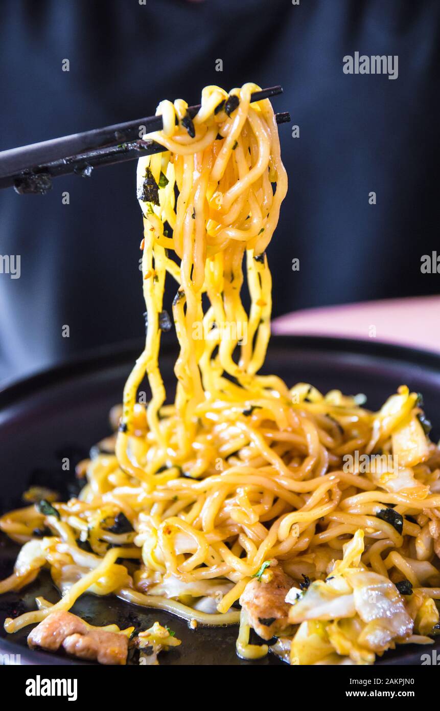japanese noodles on chopsticks, focus on noodles under chopsticks Stock