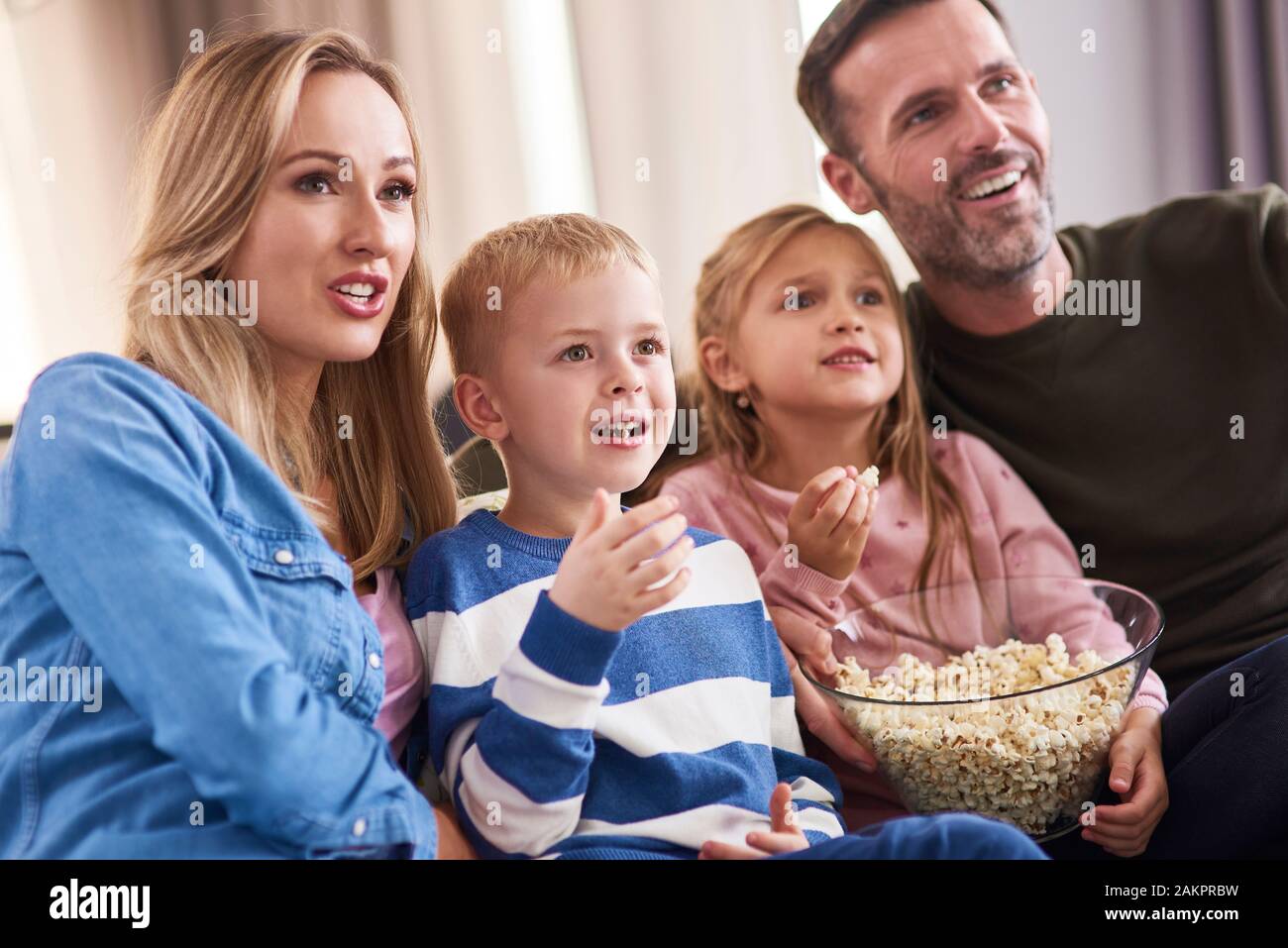 Family with two children spending time together in living room Stock Photo