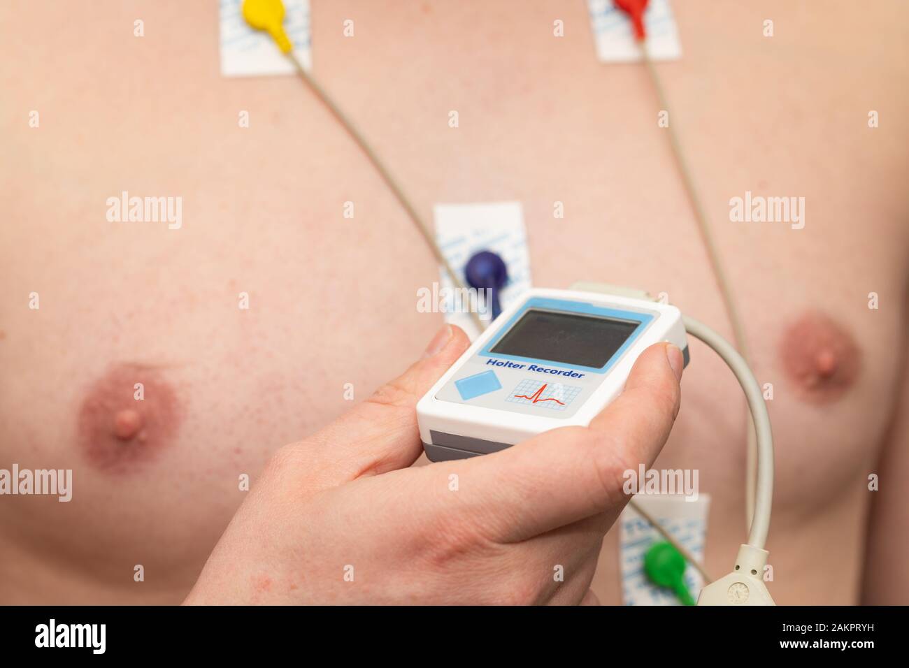 Young man with  heart diseases wearing holter monitor device for an electrocardiogram Stock Photo