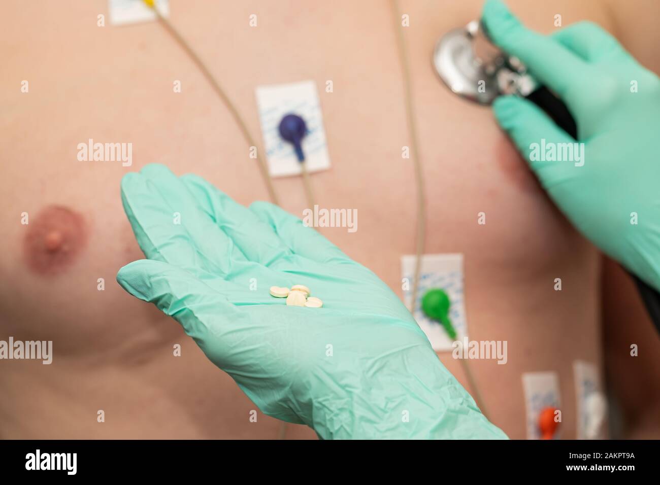Young man with  heart diseases wearing holter monitor device for an electrocardiogram Stock Photo