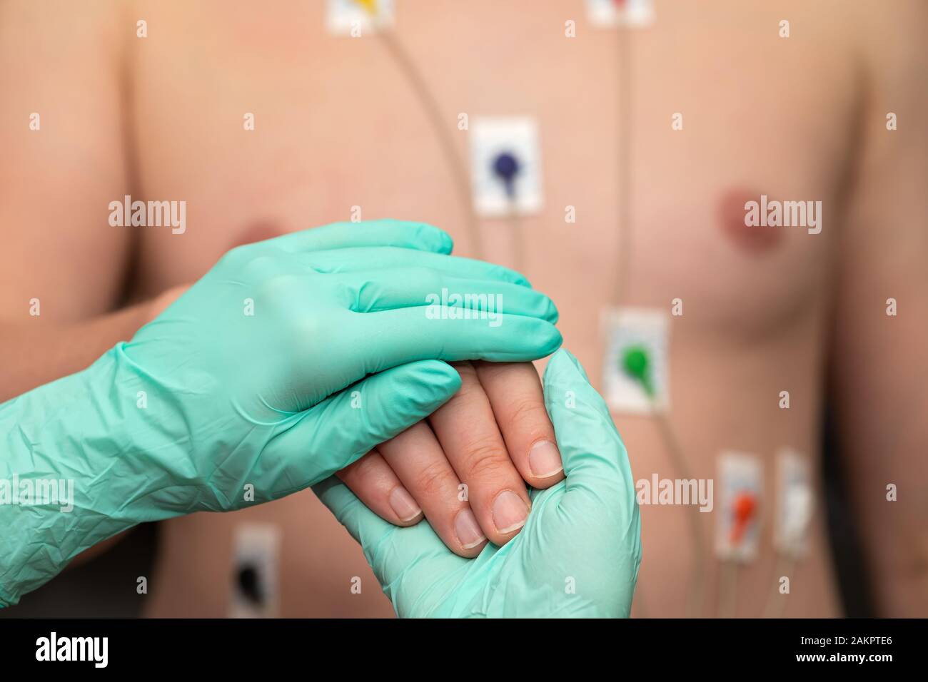 Nurse holding hands to a patient with heart disease Stock Photo