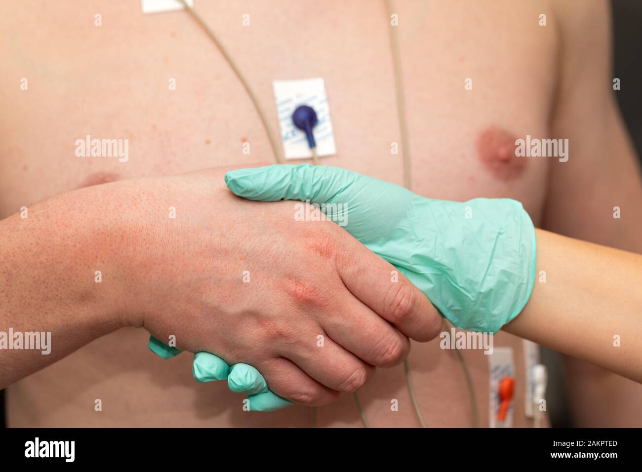 Nurse holding hands to a patient with heart disease Stock Photo