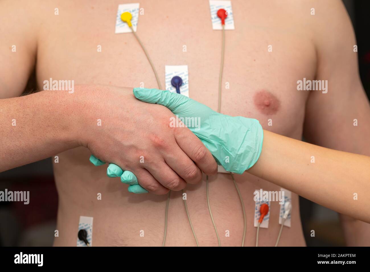 Nurse holding hands to a patient with heart disease Stock Photo