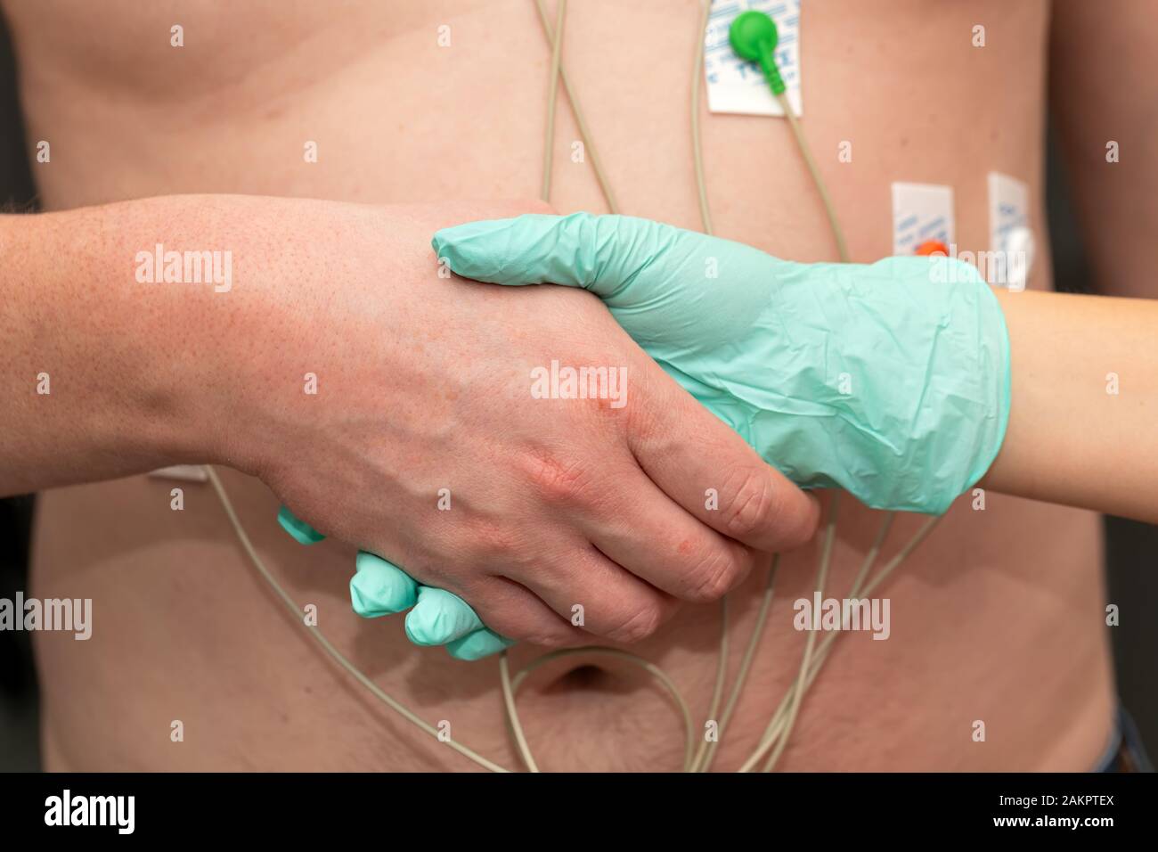 Nurse holding hands to a patient with heart disease Stock Photo