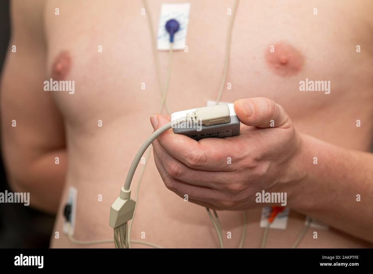 Young man with  heart diseases wearing holter monitor device for an electrocardiogram Stock Photo