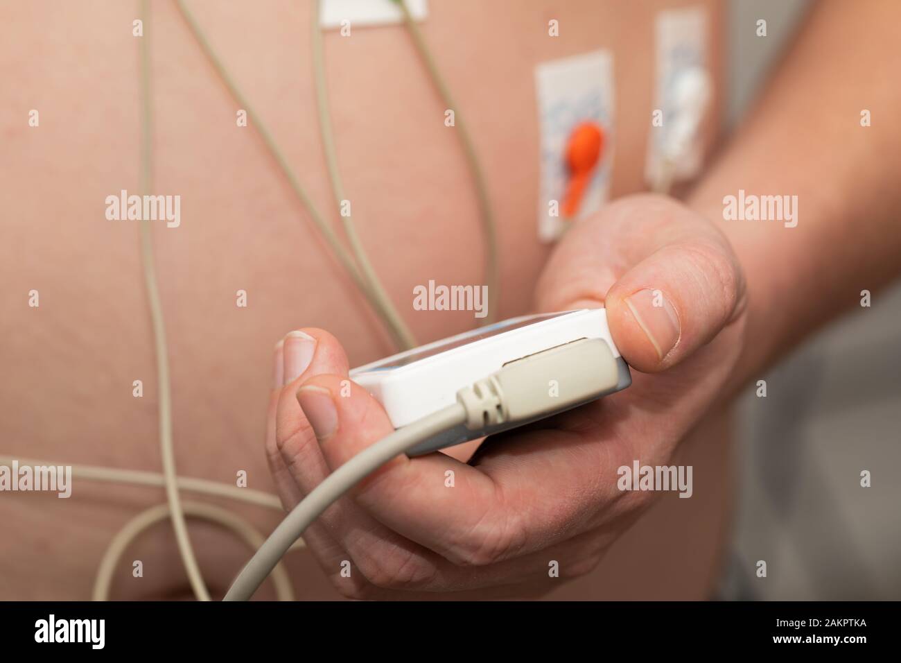 Young man with  heart diseases wearing holter monitor device for an electrocardiogram Stock Photo
