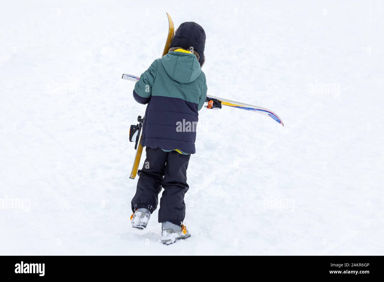 Snowboarder goes uphill with snowboard in hands. Backcountry skiing concept  Stock Photo - Alamy