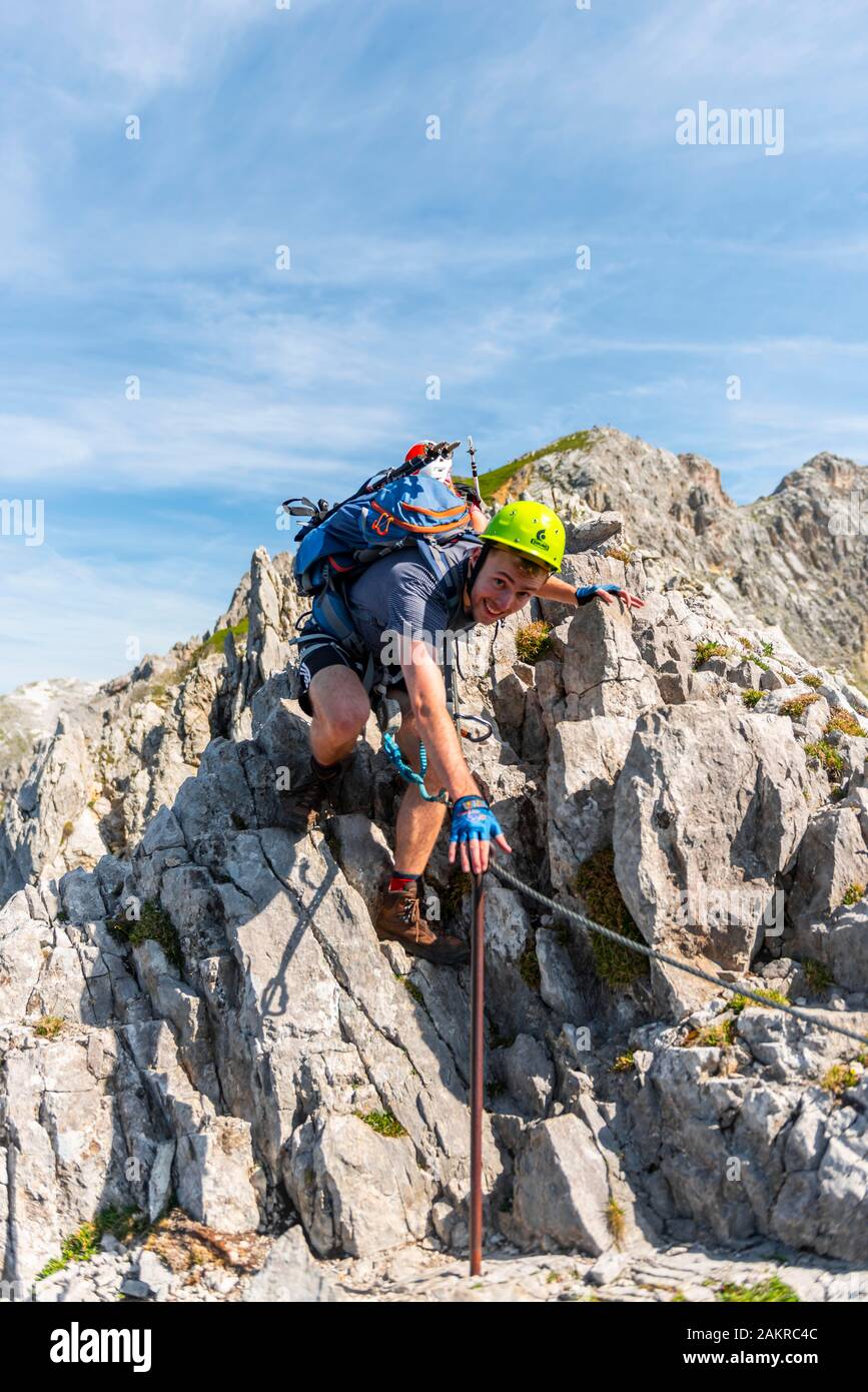 Mountaineer, young man climbs over rocks, mountaineer on a secured via ferrata, Mittenwald via ferrata, Karwendel Mountains, Mittenwald, Germany Stock Photo