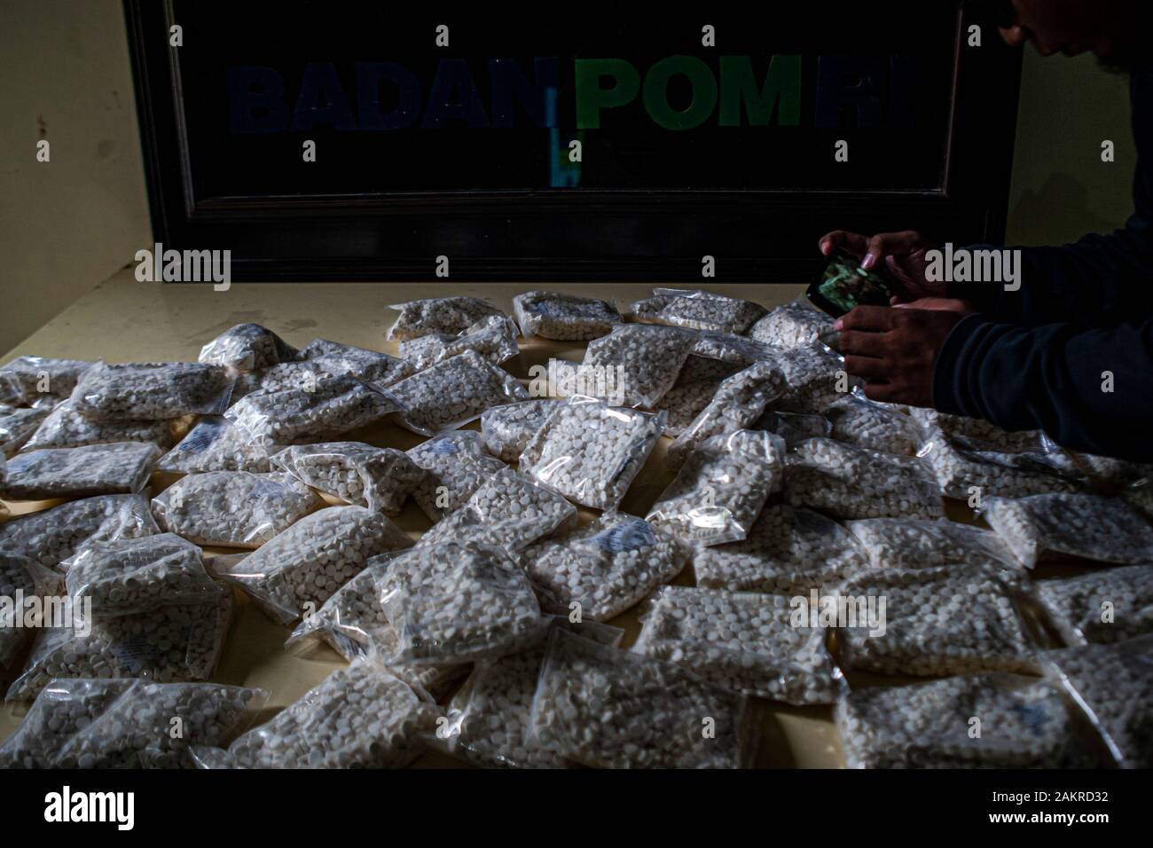 A person takes photos  of illegal drugs at the BPOM Office in Palu city.The Palu City Food and Drug Supervisory Agency (BPOM) secures 400,000 drugs without a marketing authorisation from a seller. This drug if consumed in excessive amounts can cause illness to death because it has a high dose. Stock Photo
