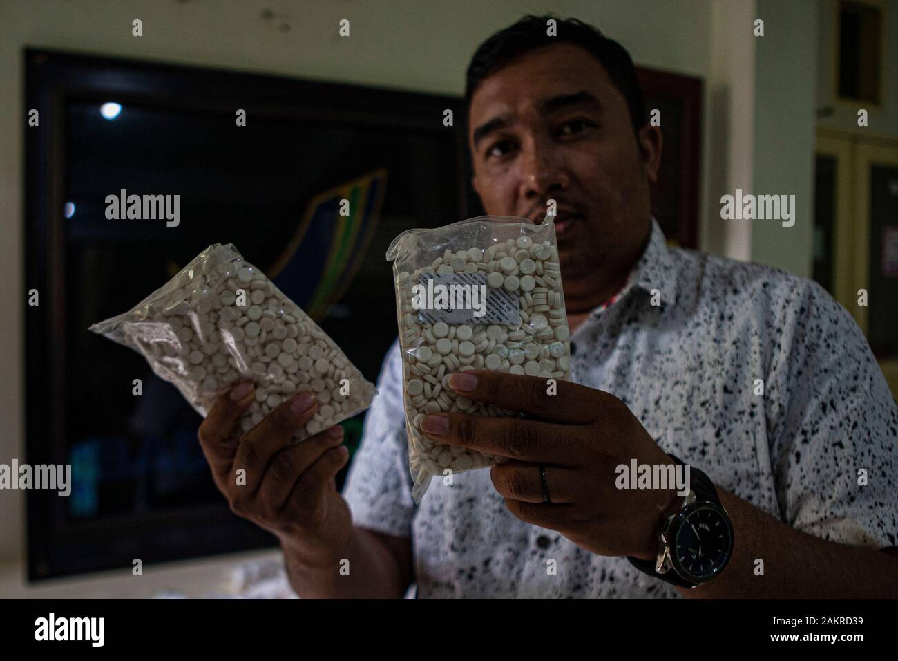 An officer shows illegal drugs at the BPOM Office in Palu city.The Palu City Food and Drug Supervisory Agency (BPOM) secures 400,000 drugs without a marketing authorisation from a seller. This drug if consumed in excessive amounts can cause illness to death because it has a high dose. Stock Photo