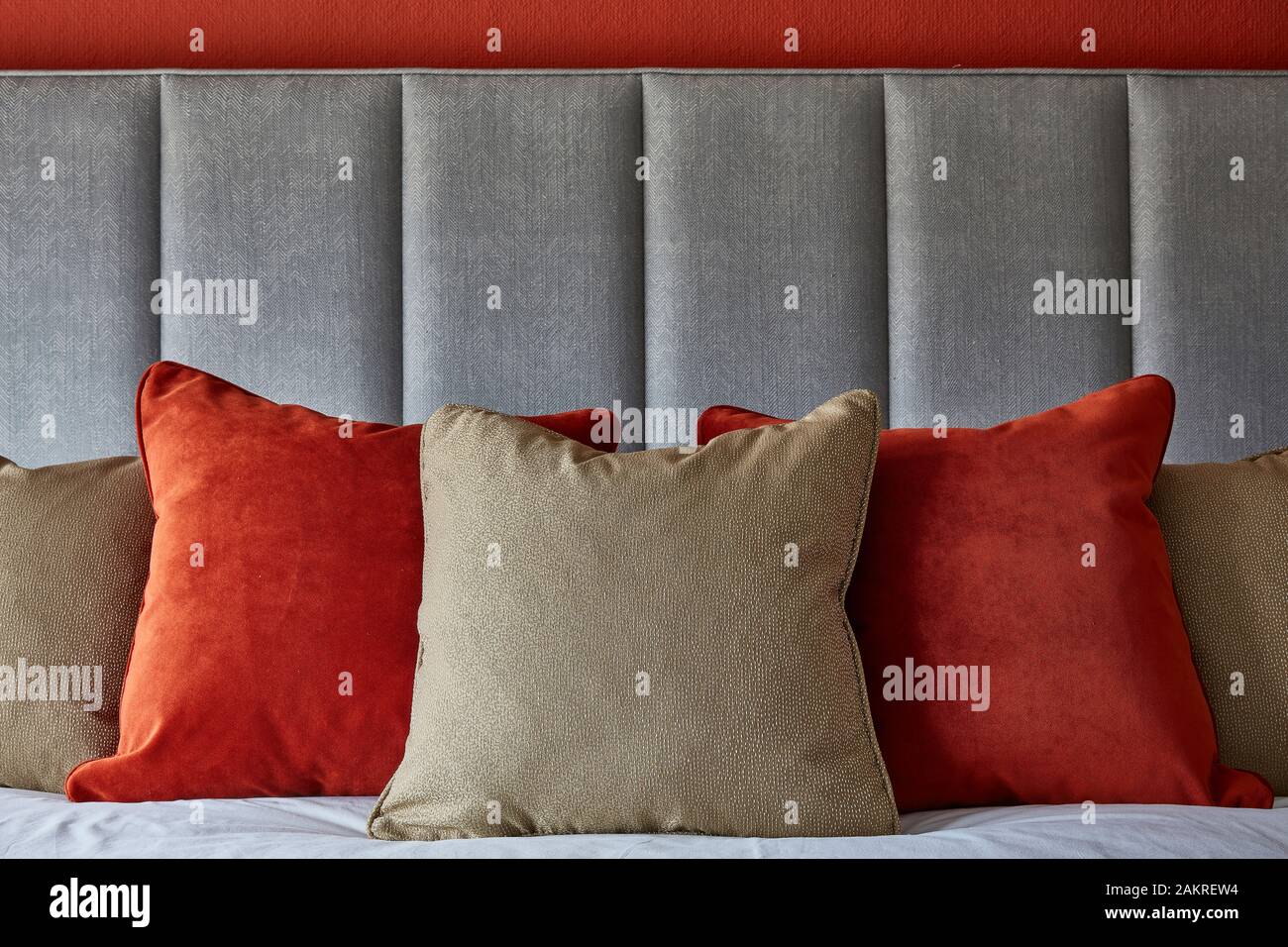 cushions on grey headboard Stock Photo
