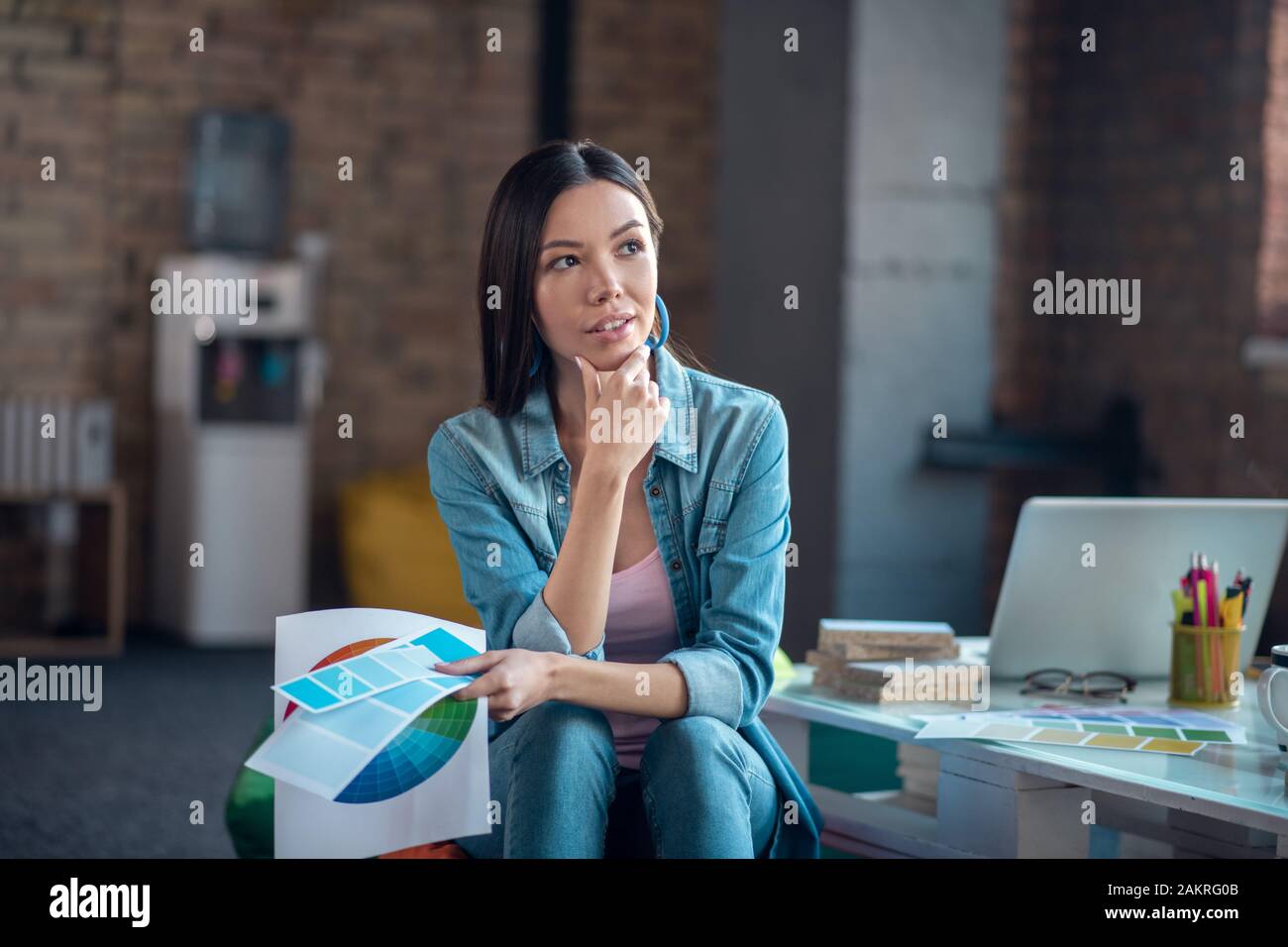 Nice young Asian woman holding her chin Stock Photo - Alamy