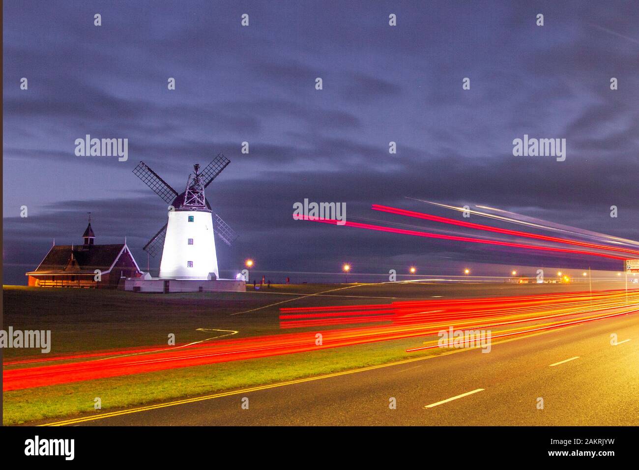 Lytham, Lancashire. UK Weather.10th Jan, 2020.Muted colours at dawnm and blurred lights from traffic leavig red trails, after a cold night on the Fylde coast. Lytham Windmill as sunrises on Lytham Green in the coastal town of Lytham St Annes, Lancashire, England. It is of the type known as a tower mill and was designed for grinding wheat and oats to make flour or bran. Credit; MediaWorldImages/AlamyLiveNews Stock Photo