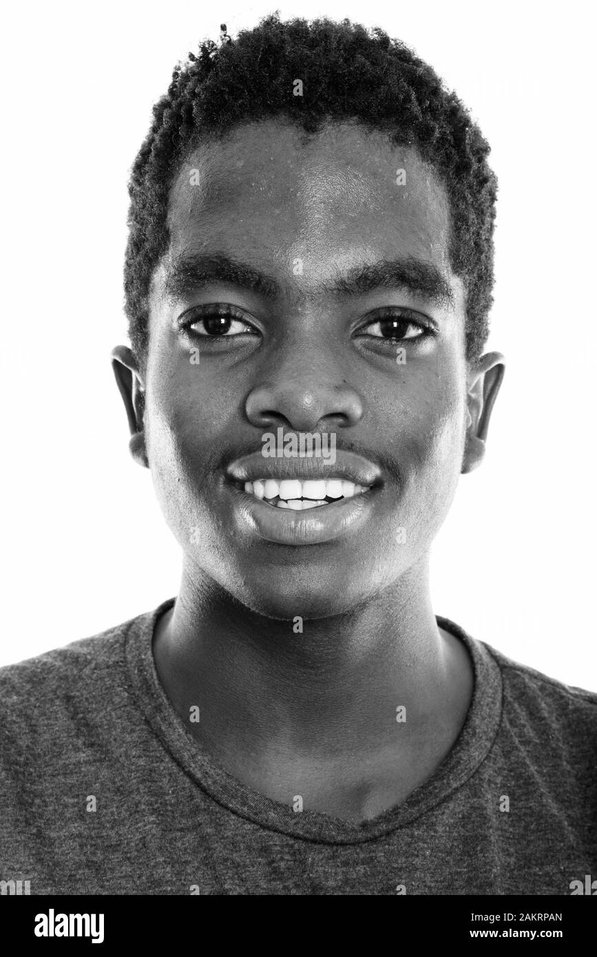 Face of young happy black African teenage boy smiling from Botswana Stock Photo