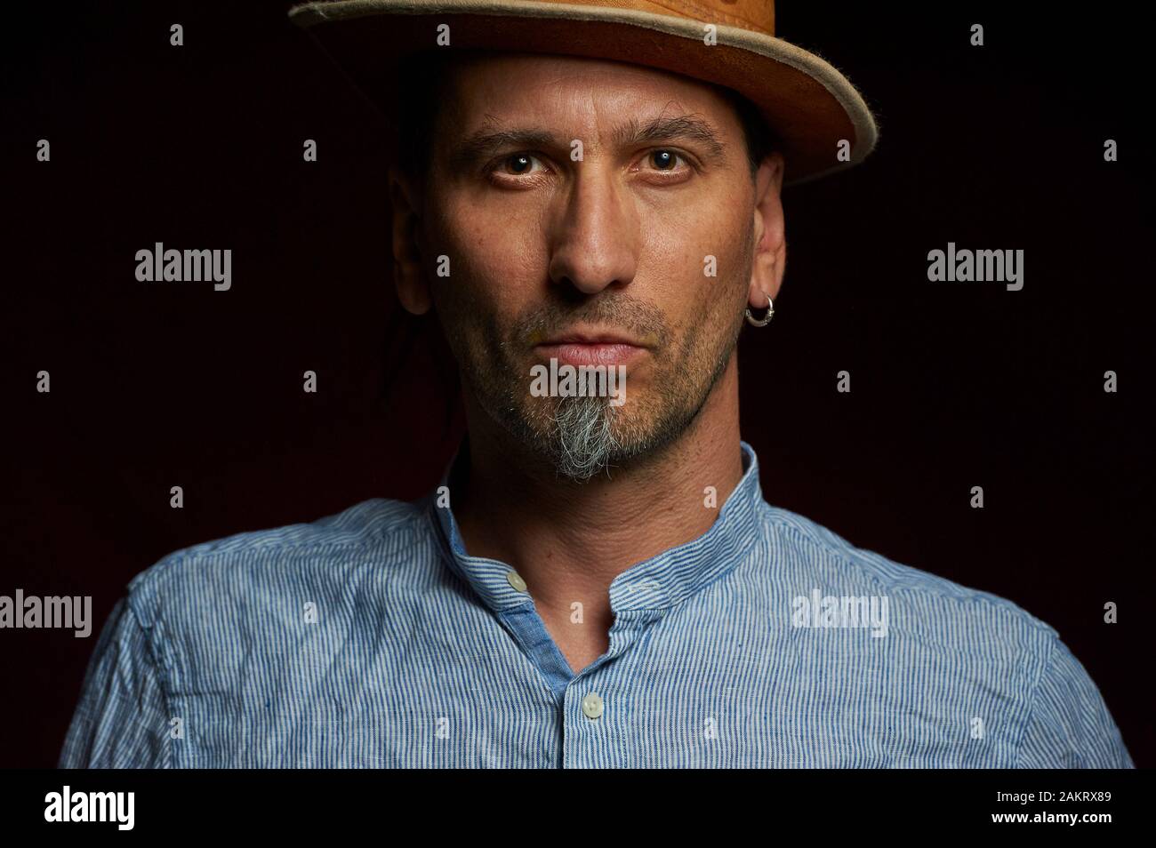 Portrait of a middle-aged man in a hat on a black background Stock Photo