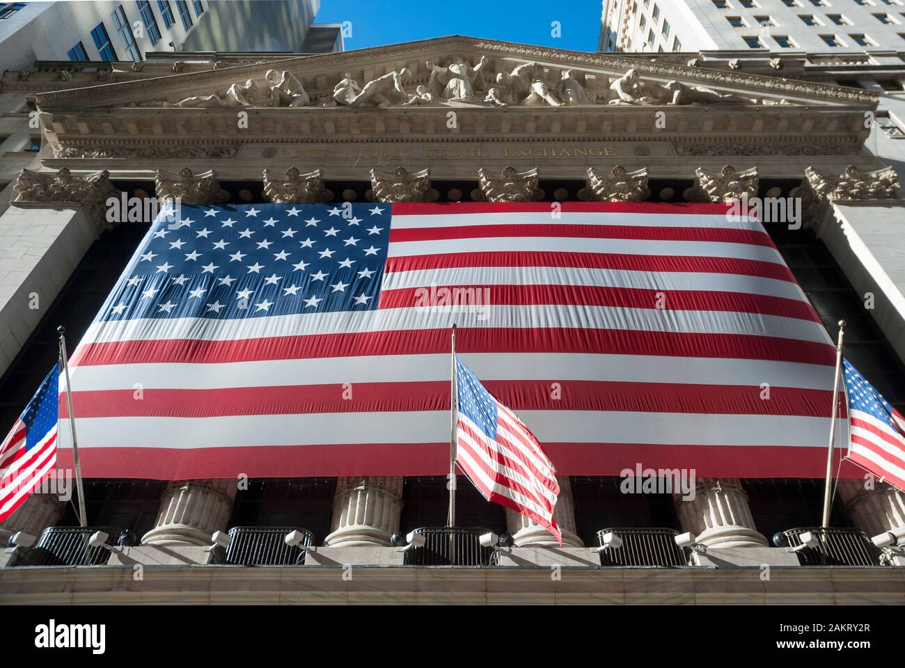 NEW YORK CITY - NOVEMBER 23, 2007: Massive American flag stretches over the facade of the New York Stock Exchange, a national historic landmark. Stock Photo