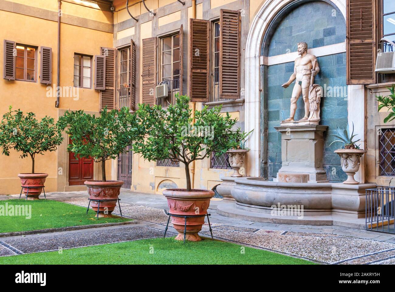 Outer courtyard of the Medici Riccardi Palace, which has an Italian garden with statues and tubs with plants. Florence, Italy Stock Photo