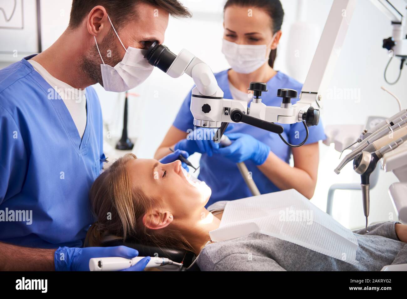 Male dentist working with dental microscope Stock Photo