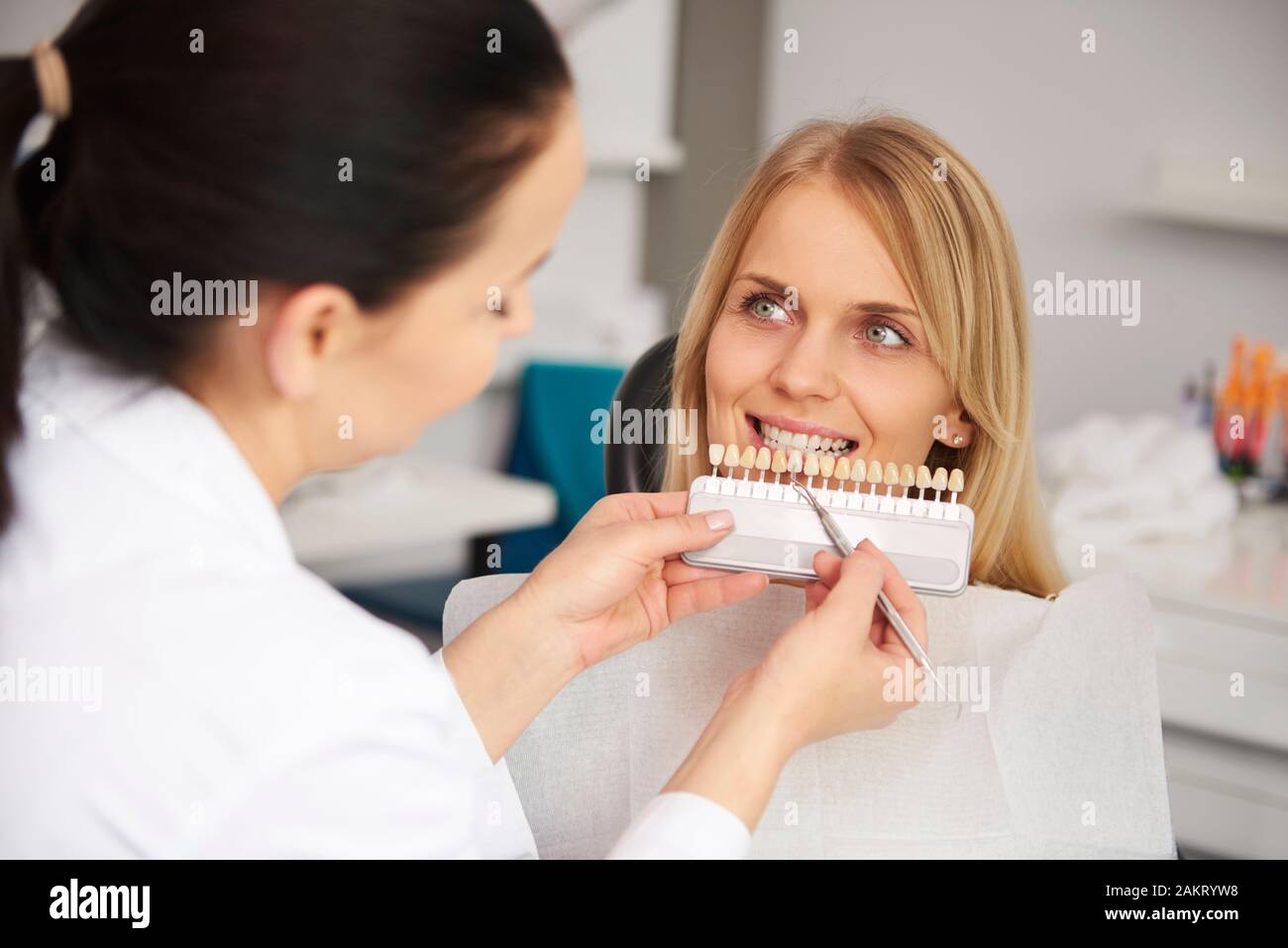 Dentist choosing color teeth from palette Stock Photo