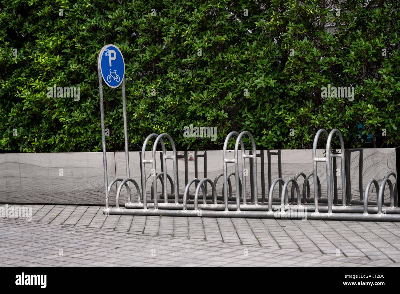 Empty stainless steel bicycle parking rack with a sign of bicycle ...