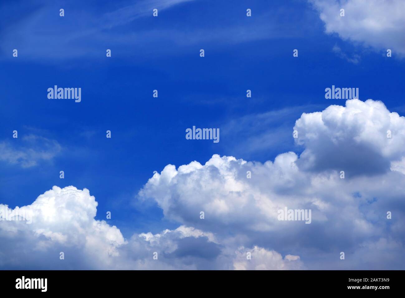 Vivid blue sunny sky with white fluffy clouds Stock Photo - Alamy