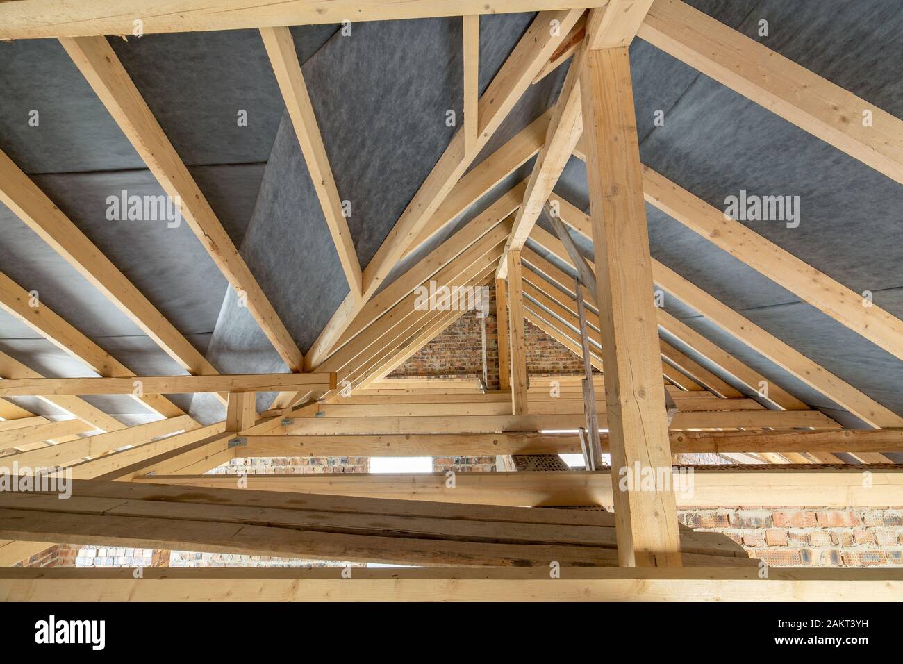 Attic space of a building under construction with wooden beams of a ...