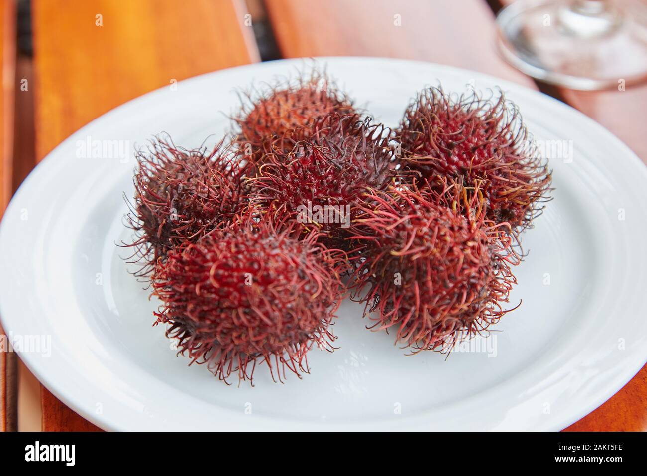 A plate of Rambutans, a spiky red fruit. Stock Photo