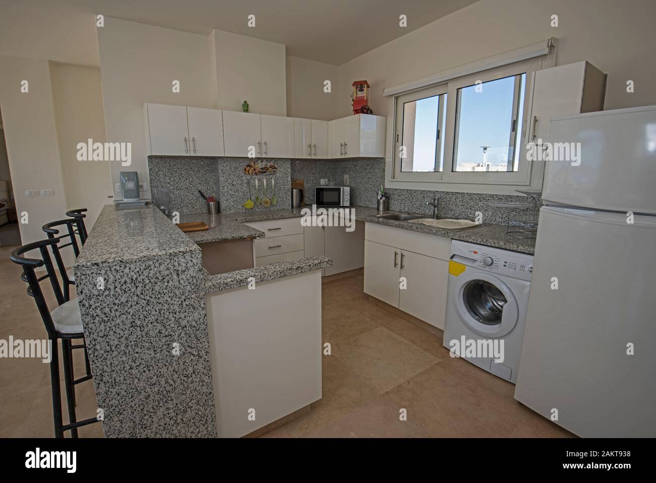 Kitchen in luxury villa show home showing interior design decor furnishing with breakfast bar Stock Photo