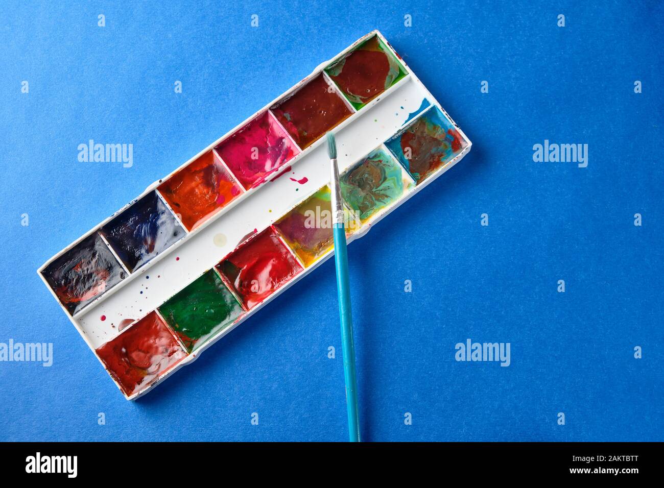 brush and water color paint at blue background with copy space Stock ...