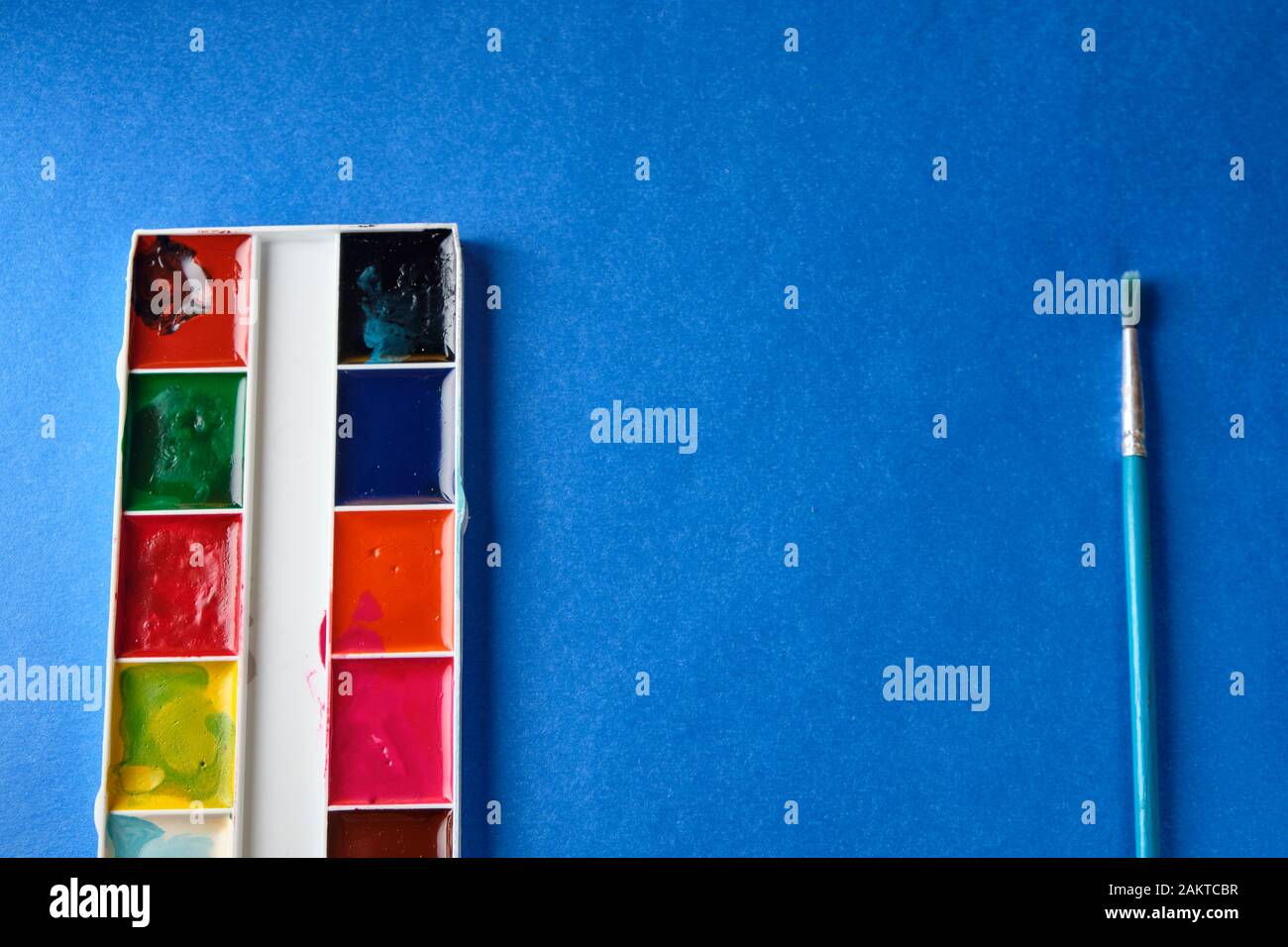 brush and water color paint at blue background with copy space Stock ...