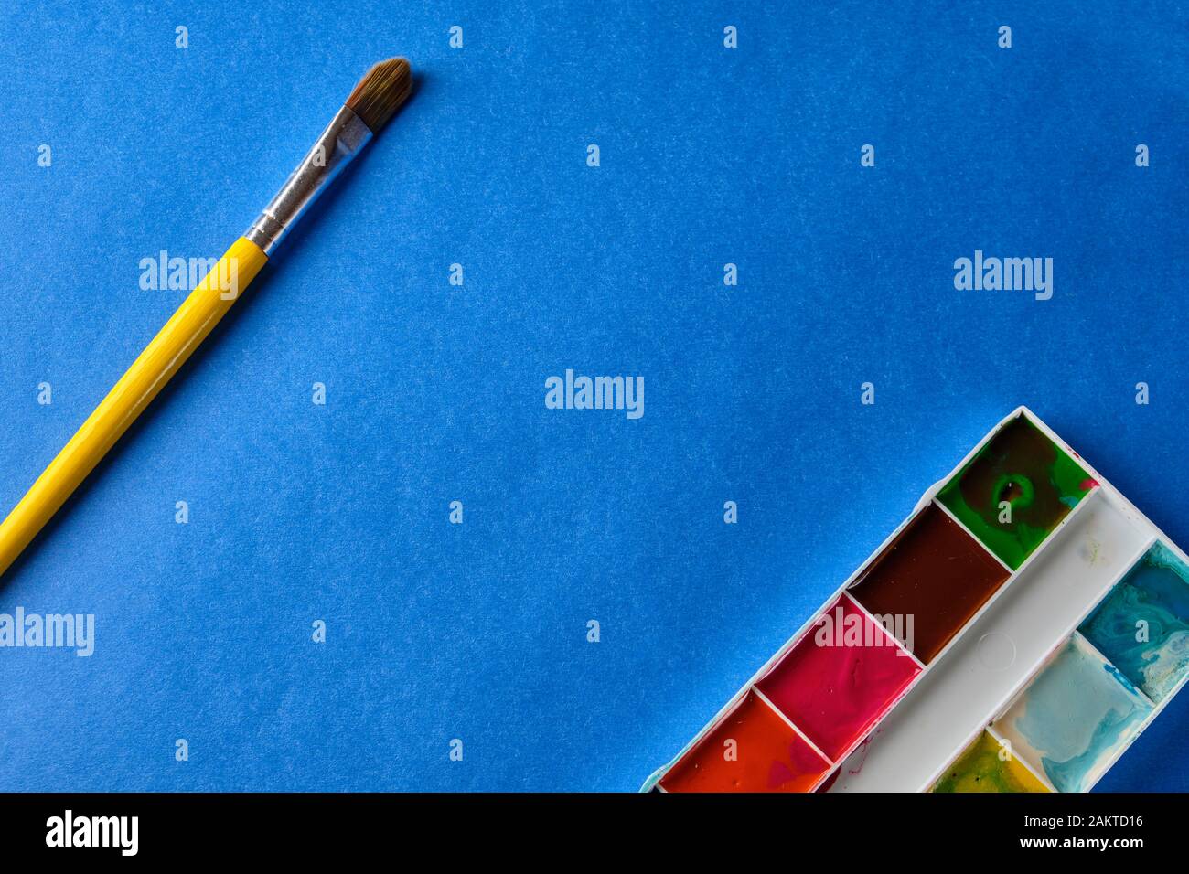 brush and water color paint at blue background with copy space Stock ...
