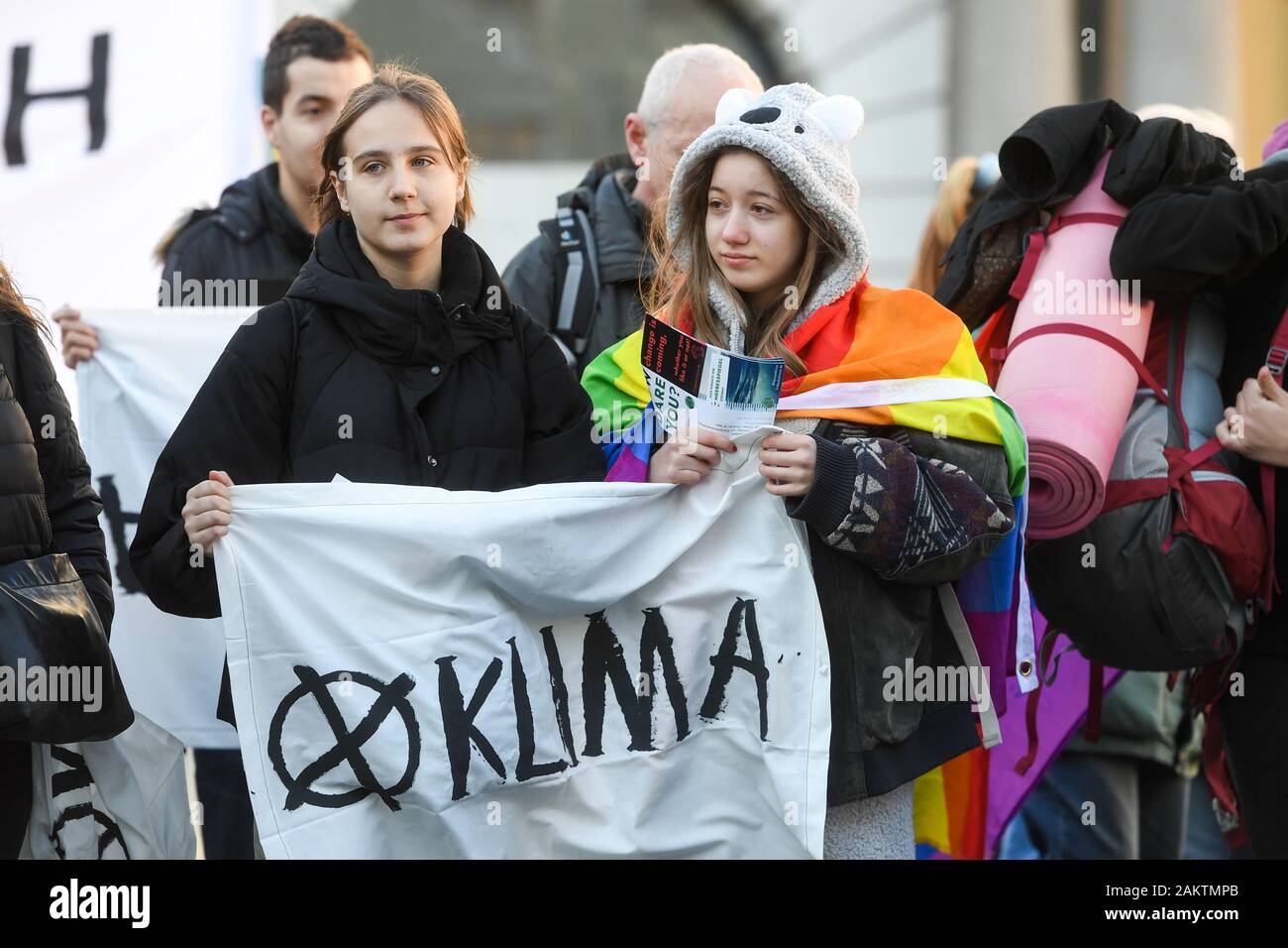 Munich, Germany. 10th Jan, 2020. Two participants of a demonstration in front of the headquarters of the electrical company Siemens at Wittelsbacher Platz hold a poster with the inscription 'Climate' in their hands, one of them wearing a costume reminiscent of an Australian koala. The climate movement Fridays for Future has called for a demonstration to protest against Siemens' technical equipment for an Australian coal mining project. The Indian concern Adani wants to implement the mining project. Credit: dpa picture alliance/Alamy Live News Stock Photo