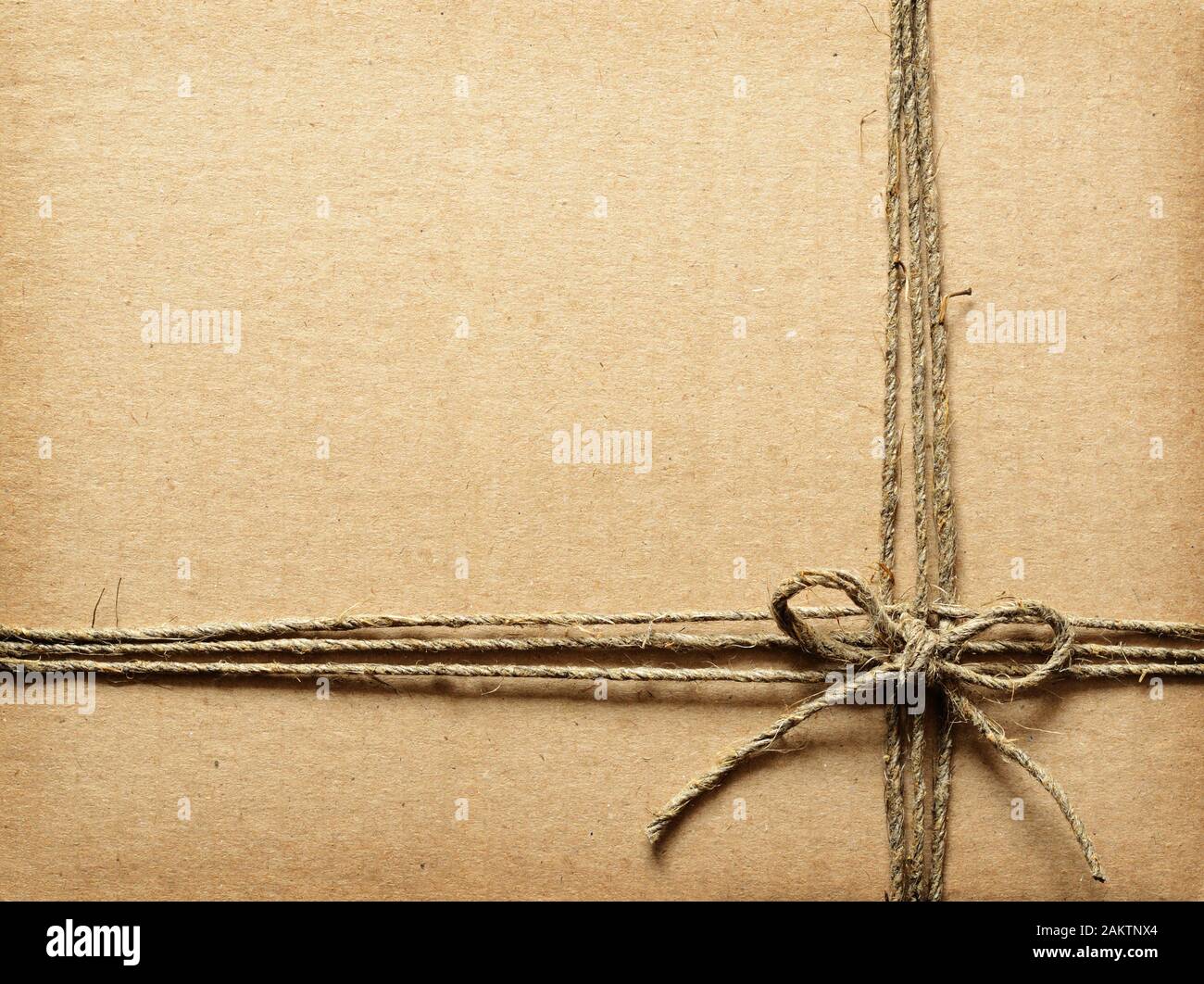 Wrapping Rope On Cardboard Brown cardboard tied with rope Stock Photo - Alamy