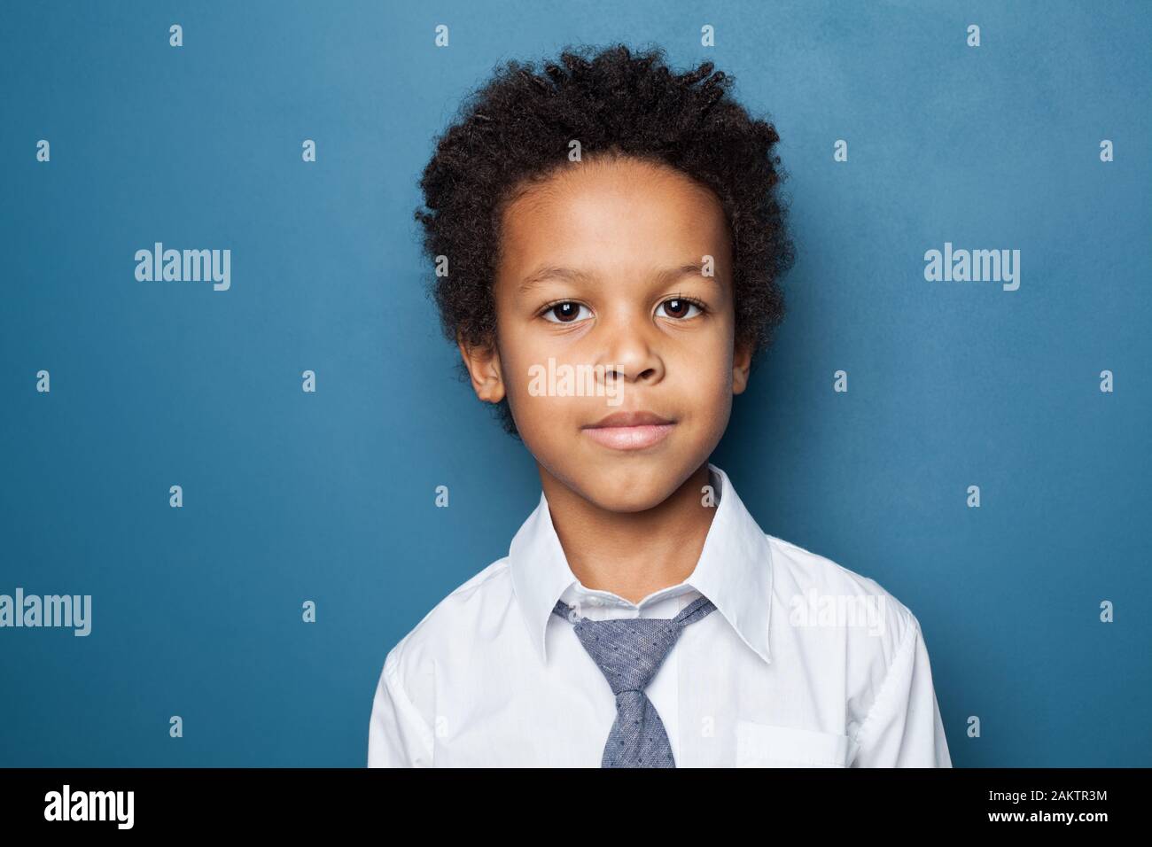 Portrait of cute kid school boy. Little african american child on blue ...