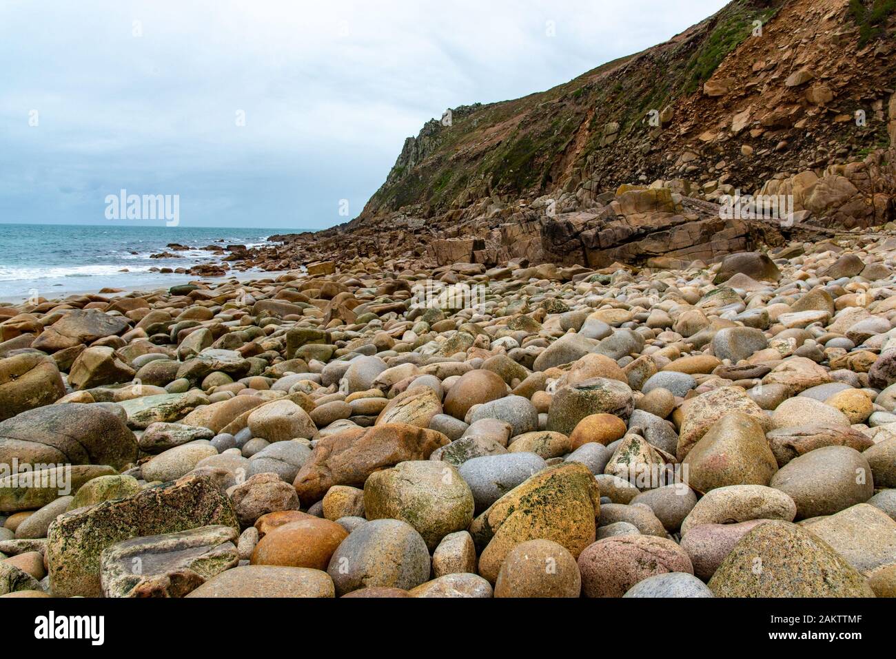The 'Dinosaur Egg' beach at Porth Nanven, St Just, Cornwall is composed of large rounded boulders. Stock Photo