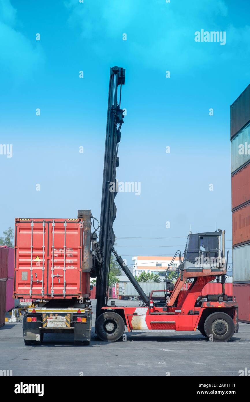 Container stacker, load the container into the truck. Transportation ...