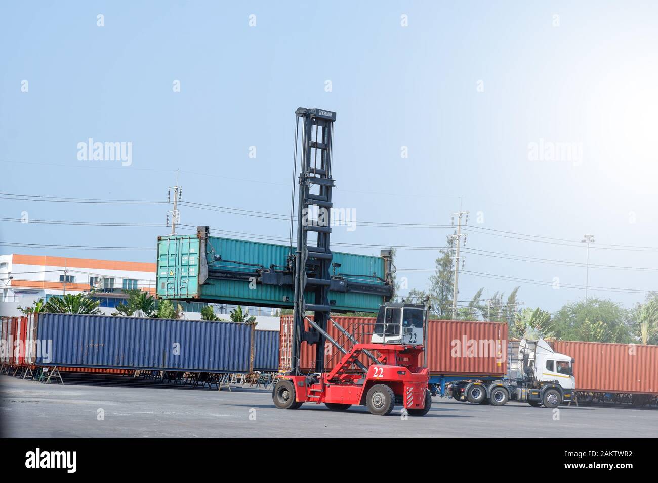 Container stacker, load the container into the truck. Transportation ...