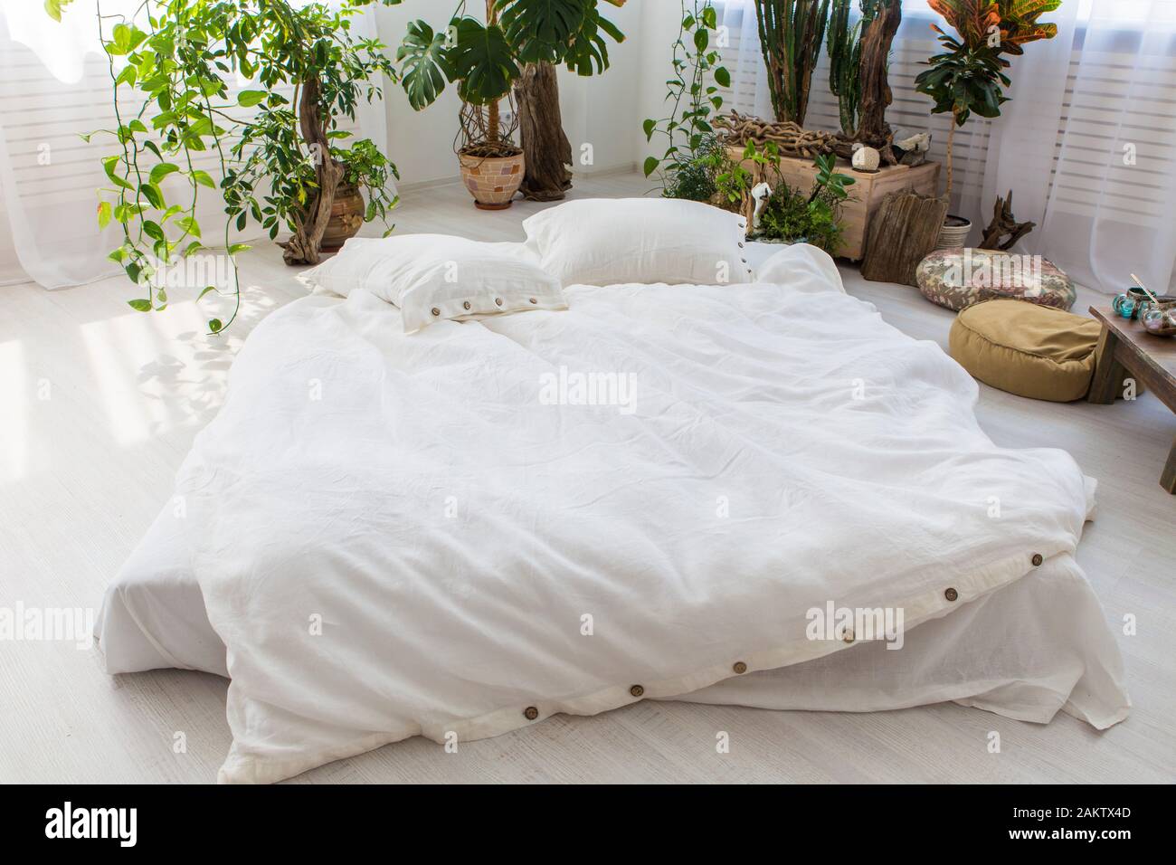 natural ecofriendly linen bed in the interior Stock Photo Alamy