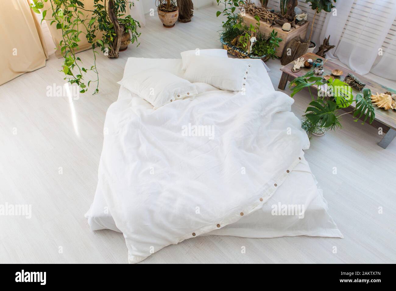natural ecofriendly linen bed in the interior Stock Photo Alamy