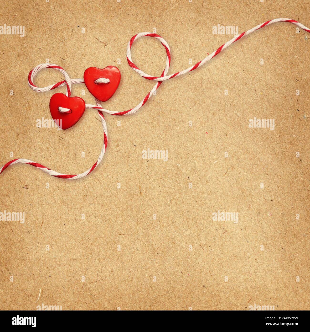 Two hearts tied with rope on craft paper background for Valentine's Day ...