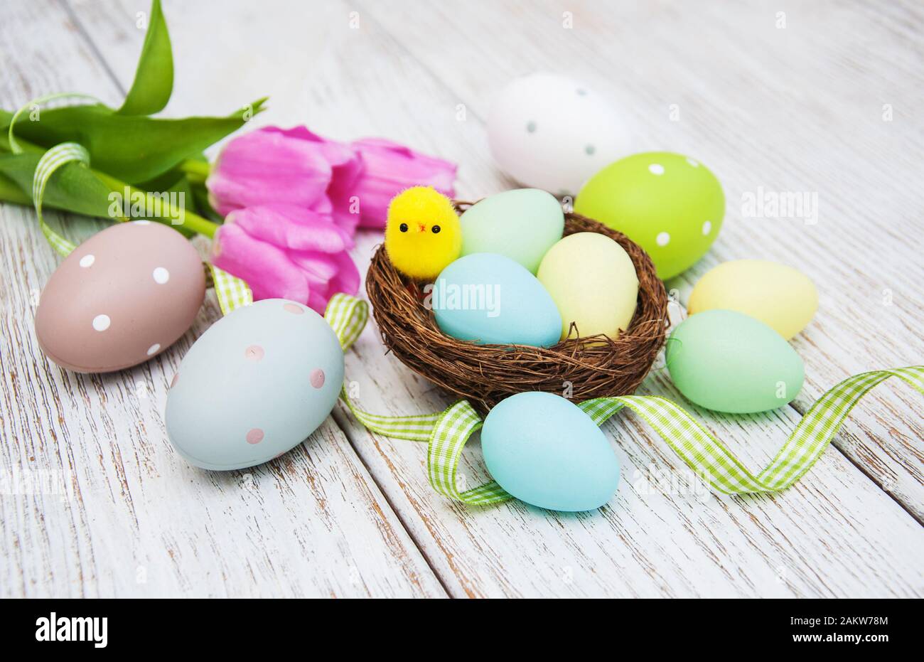 Easter eggs and tulips on a old wooden background Stock Photo - Alamy