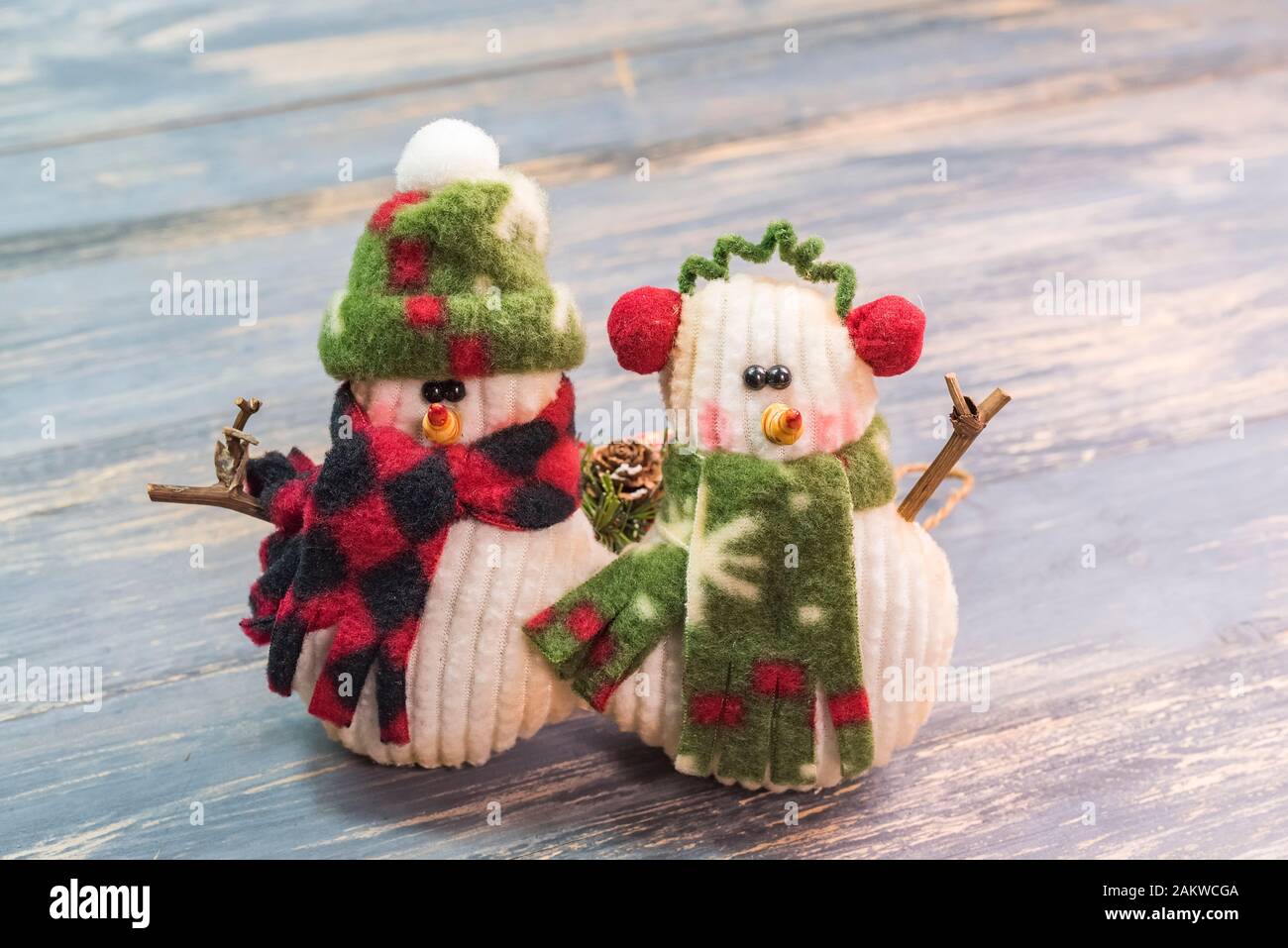 snowmans holding blackboard on wooden background Stock Photo