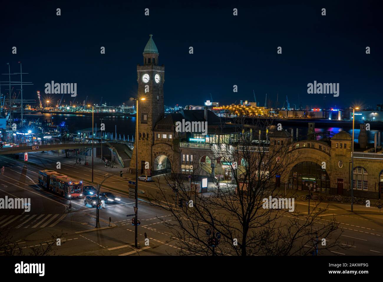 Panoramic shot at night of St Pauli Landungsbruecken landing place in Port of Hamburg between the lower harbour and Fish Market on Elbe river Stock Photo
