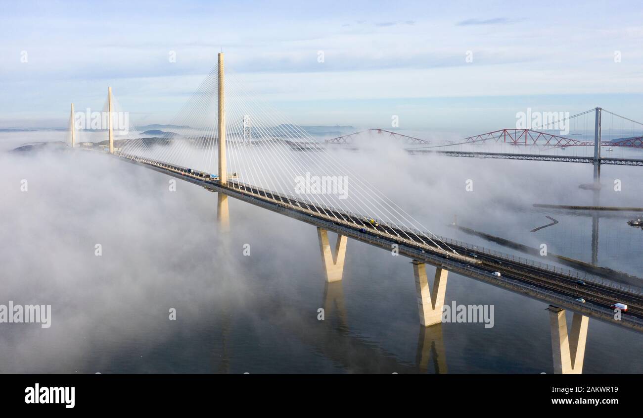 South Queensferry, Scotland, UK. 10th Jan 2020. Drone image of a spectacular cloud inversion at Queensferry Crossing Bridge with the lower half of the bridge shrouded in fog but the upper half in beautiful sunny weather. In background the Forth Bridge and Forth Road Bridge. Iain Masterton/Alamy Live News Stock Photo